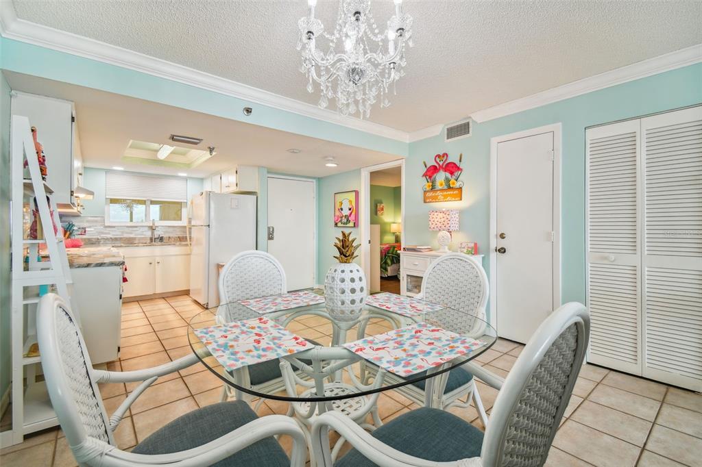 5915 Sea Ranch Drive, Unit 308 Hudson, FL 34667 - Photo 19 of 64 a living room with furniture and a chandelier