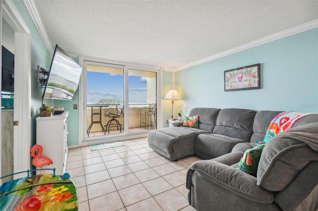 5915 Sea Ranch Drive, Unit 308 Hudson, FL 34667 - Photo 22 of 64 a living room with furniture and a floor to ceiling window