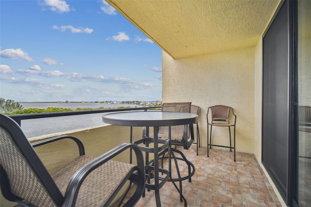5915 Sea Ranch Drive, Unit 308 Hudson, FL 34667 - Photo 26 of 64 a view of a swimming pool with a table and chairs