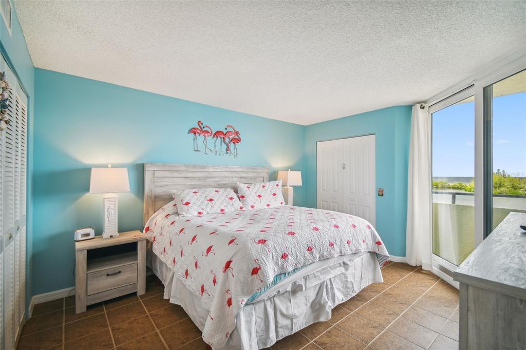5915 Sea Ranch Drive, Unit 308 Hudson, FL 34667 - Photo 30 of 64 a bedroom with a bed and a painting on the wall