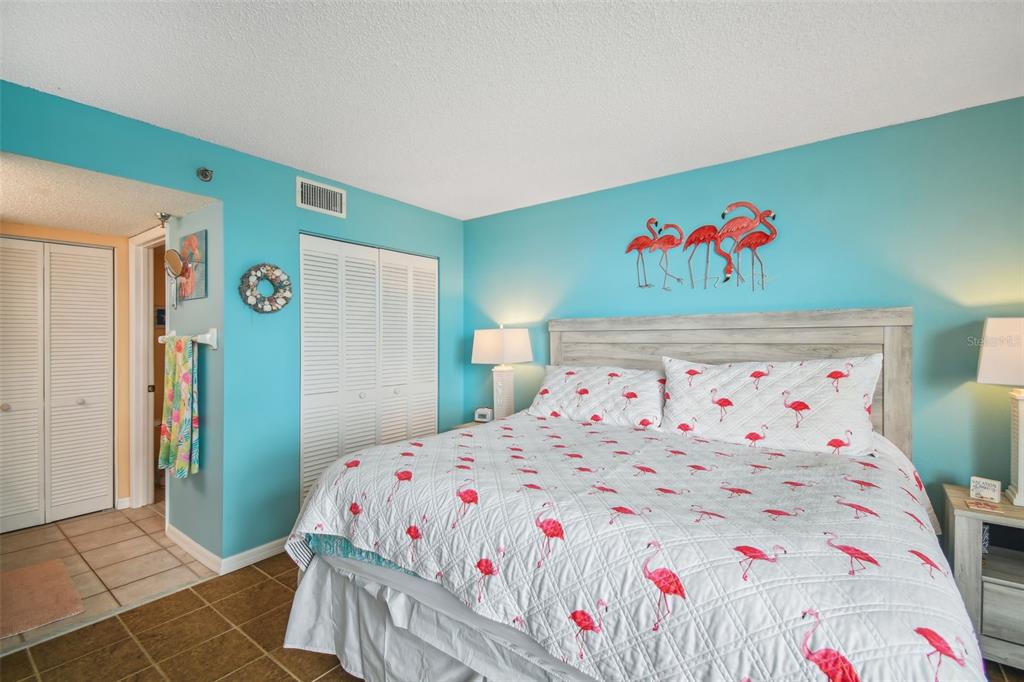 5915 Sea Ranch Drive, Unit 308 Hudson, FL 34667 - Photo 31 of 64 a bedroom with a bed and a white comforter
