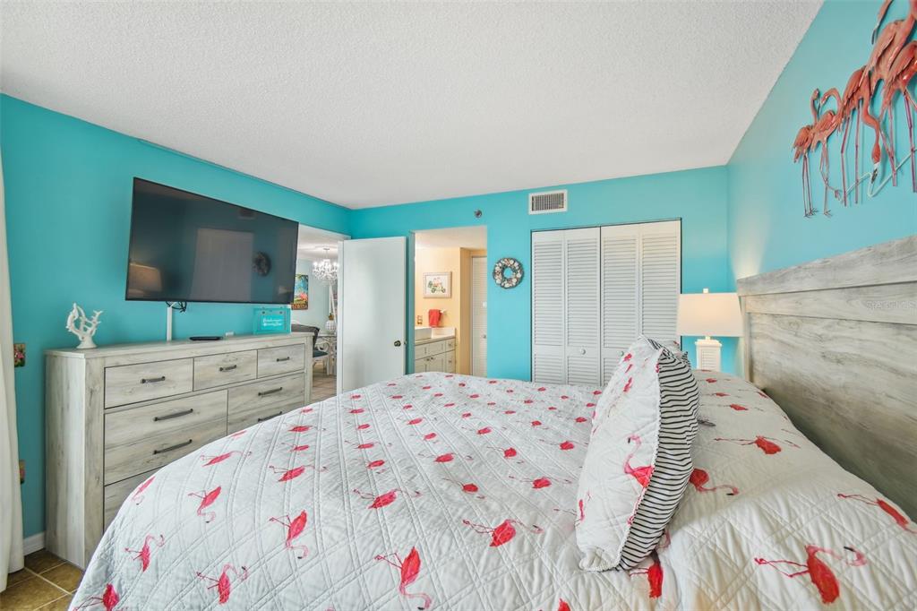 5915 Sea Ranch Drive, Unit 308 Hudson, FL 34667 - Photo 32 of 64 a bedroom with a bed and a flat screen tv in it