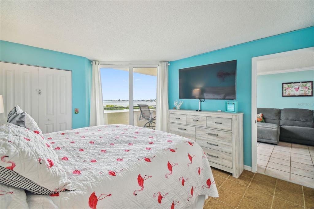 5915 Sea Ranch Drive, Unit 308 Hudson, FL 34667 - Photo 33 of 64 a bedroom with a bed and a flat screen tv
