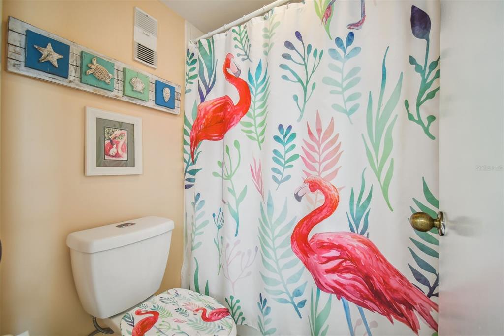 5915 Sea Ranch Drive, Unit 308 Hudson, FL 34667 - Photo 35 of 64 a bathroom with a white toilet and a shower curtain