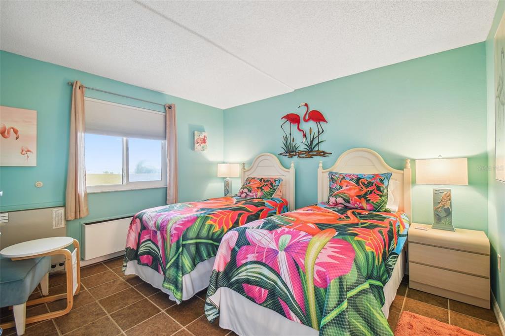 5915 Sea Ranch Drive, Unit 308 Hudson, FL 34667 - Photo 4 of 64 a bedroom with two beds and a window