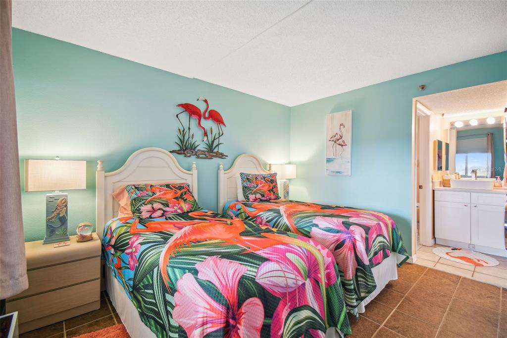 5915 Sea Ranch Drive, Unit 308 Hudson, FL 34667 - Photo 5 of 64 a bedroom with two beds and a painting on the wall