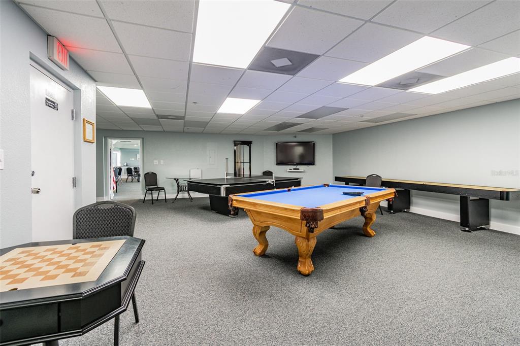 5915 Sea Ranch Drive, Unit 308 Hudson, FL 34667 - Photo 60 of 64 a living room with furniture pool table and a wooden floor