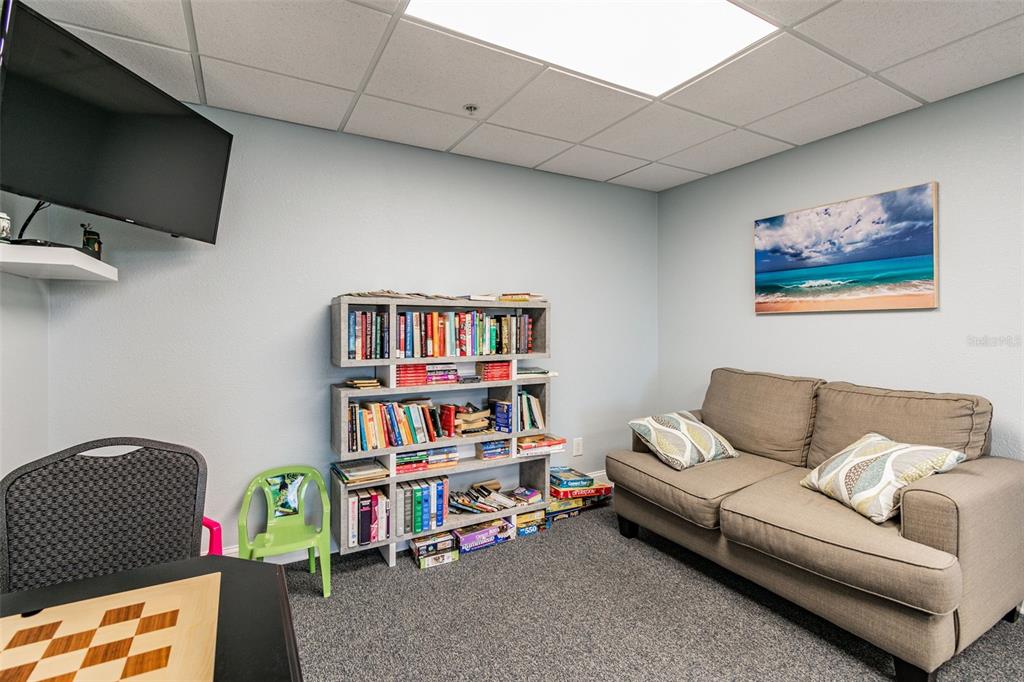 5915 Sea Ranch Drive, Unit 308 Hudson, FL 34667 - Photo 64 of 64 a living room with a couch and a book shelf