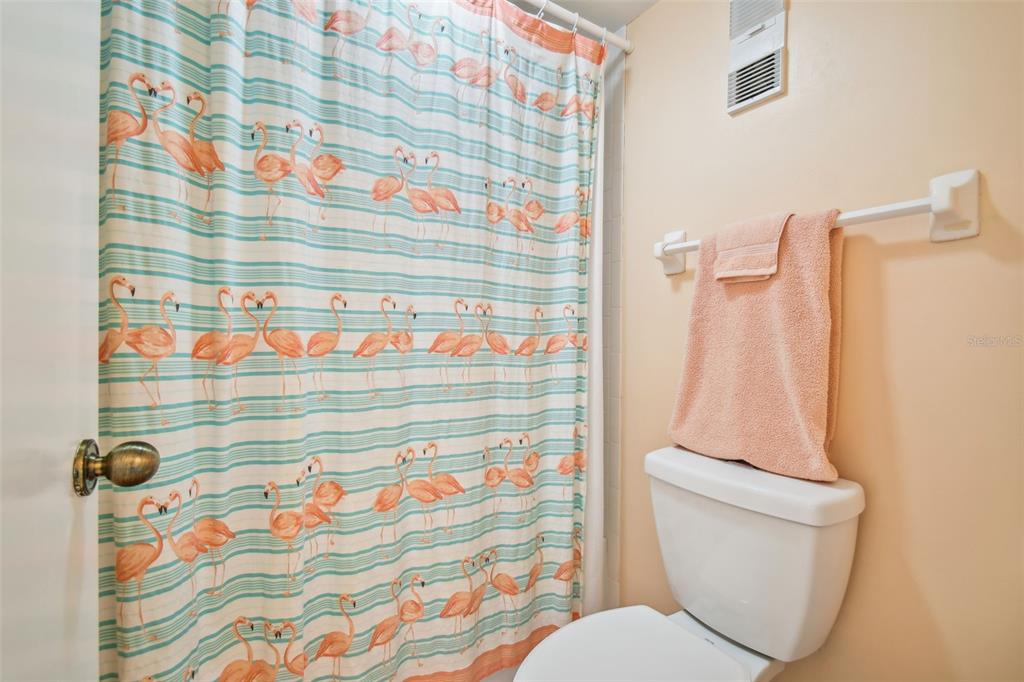 5915 Sea Ranch Drive, Unit 308 Hudson, FL 34667 - Photo 9 of 64 a bathroom with a toilet and shower curtain