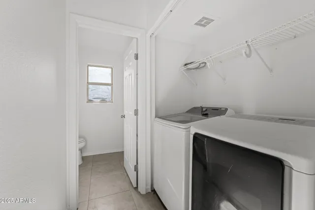 a utility room with cabinets washer and dryer