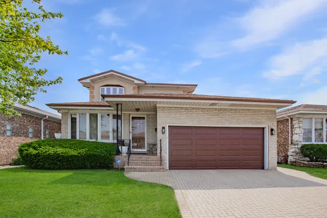 a front view of a house with a garden and yard