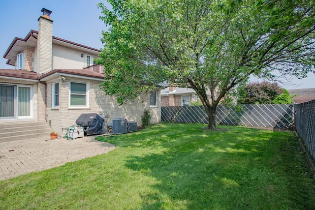 a view of a house with a yard and sitting area