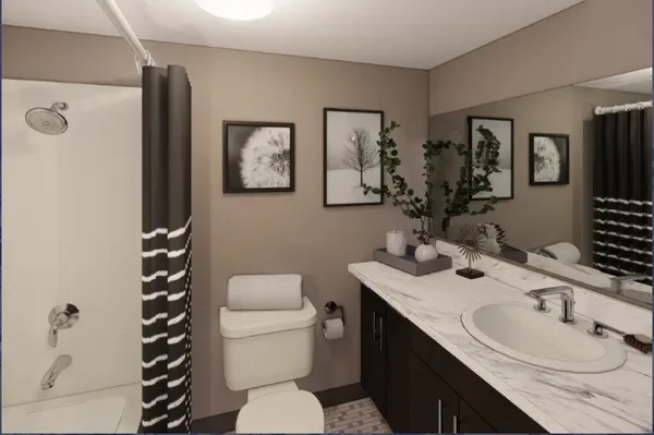 a bathroom with a granite countertop toilet sink and mirror
