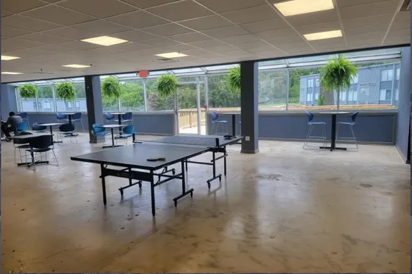 a workspace with furniture and a large window