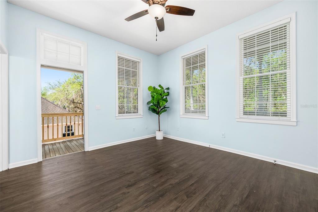 5213 Southwest 91 Terrace, Unit B Gainesville, FL 32608 - Photo 11 of 38 a view of an empty room with wooden floor and a window