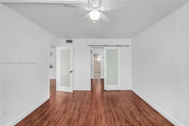 a view of hallway with wooden floor
