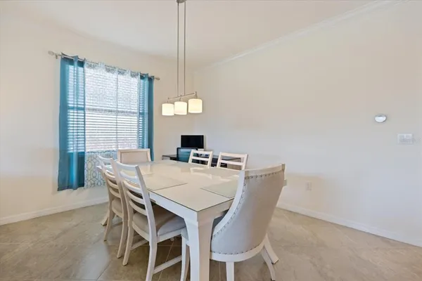 a view of a dining room that has a table and chairs in it
