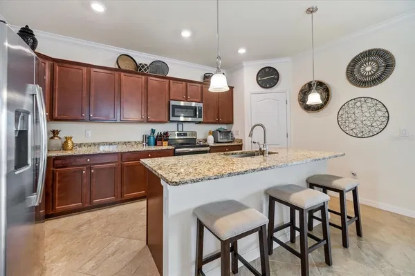 a kitchen with granite countertop a wooden table and cabinets