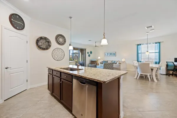 a kitchen with a table chairs and a clock on the wall