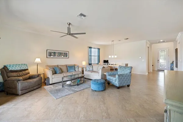a living room with furniture and a chandelier