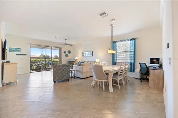 a dining room with furniture and a chandelier