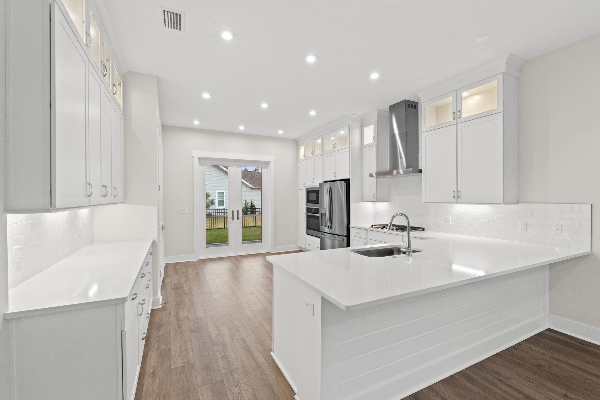 16 Ravine Rd Inlet Beach Inlet Beach, FL 32461 - Photo 12 of 31 a kitchen with kitchen island a sink appliances and cabinets