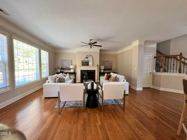 a living room with fireplace furniture and a wooden floor
