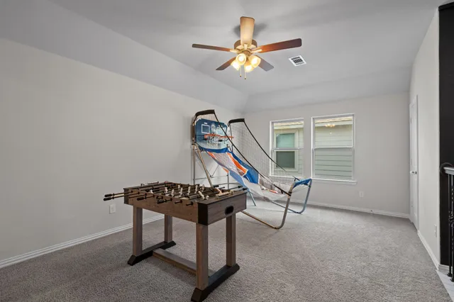 a view of a room with furniture a ceiling fan and a window