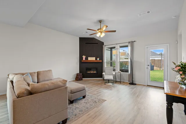a living room with furniture and a fireplace