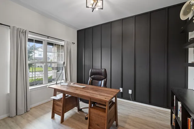 a room with a table chairs and wooden floor