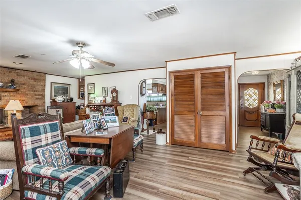 a living room with furniture a flat screen tv and a window