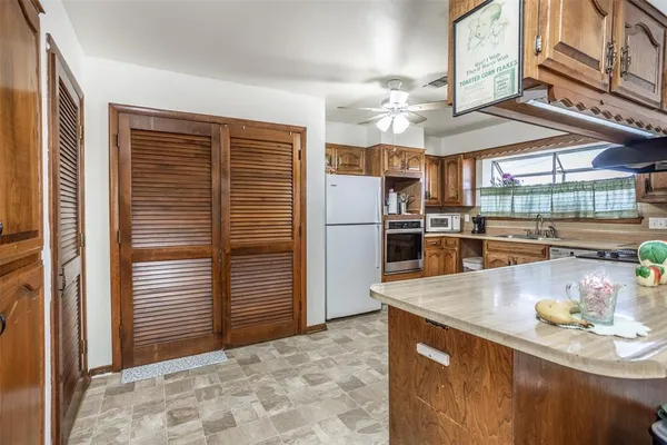 a kitchen with stainless steel appliances granite countertop a refrigerator sink and stove