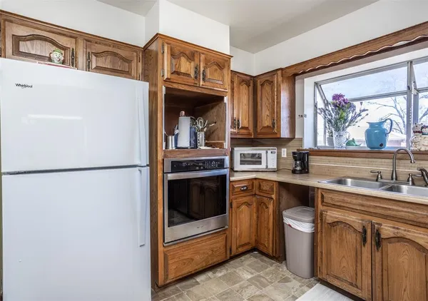 a kitchen with stainless steel appliances granite countertop a sink stove and cabinets