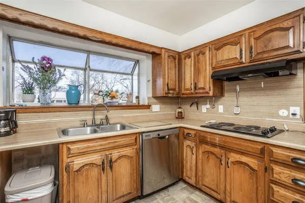 a kitchen with stainless steel appliances granite countertop a sink and cabinets