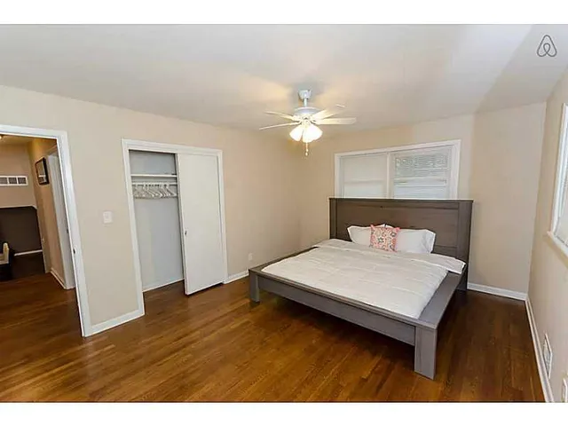 a bedroom with a bed and a ceiling fan