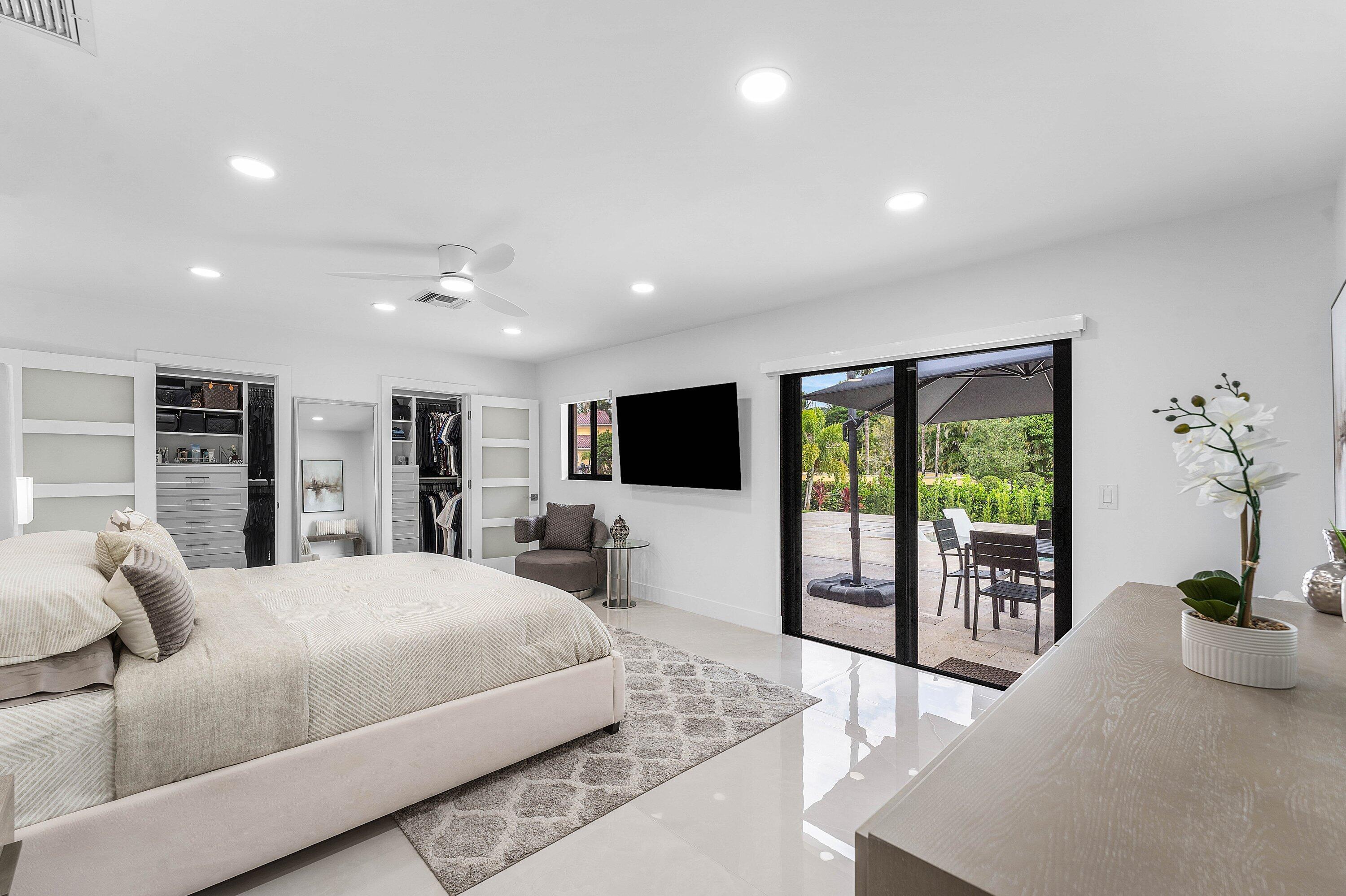 8274 Sawpine Road Delray Beach, FL 33446 - Photo 21 of 63 a bedroom with a large bed and a flat screen tv