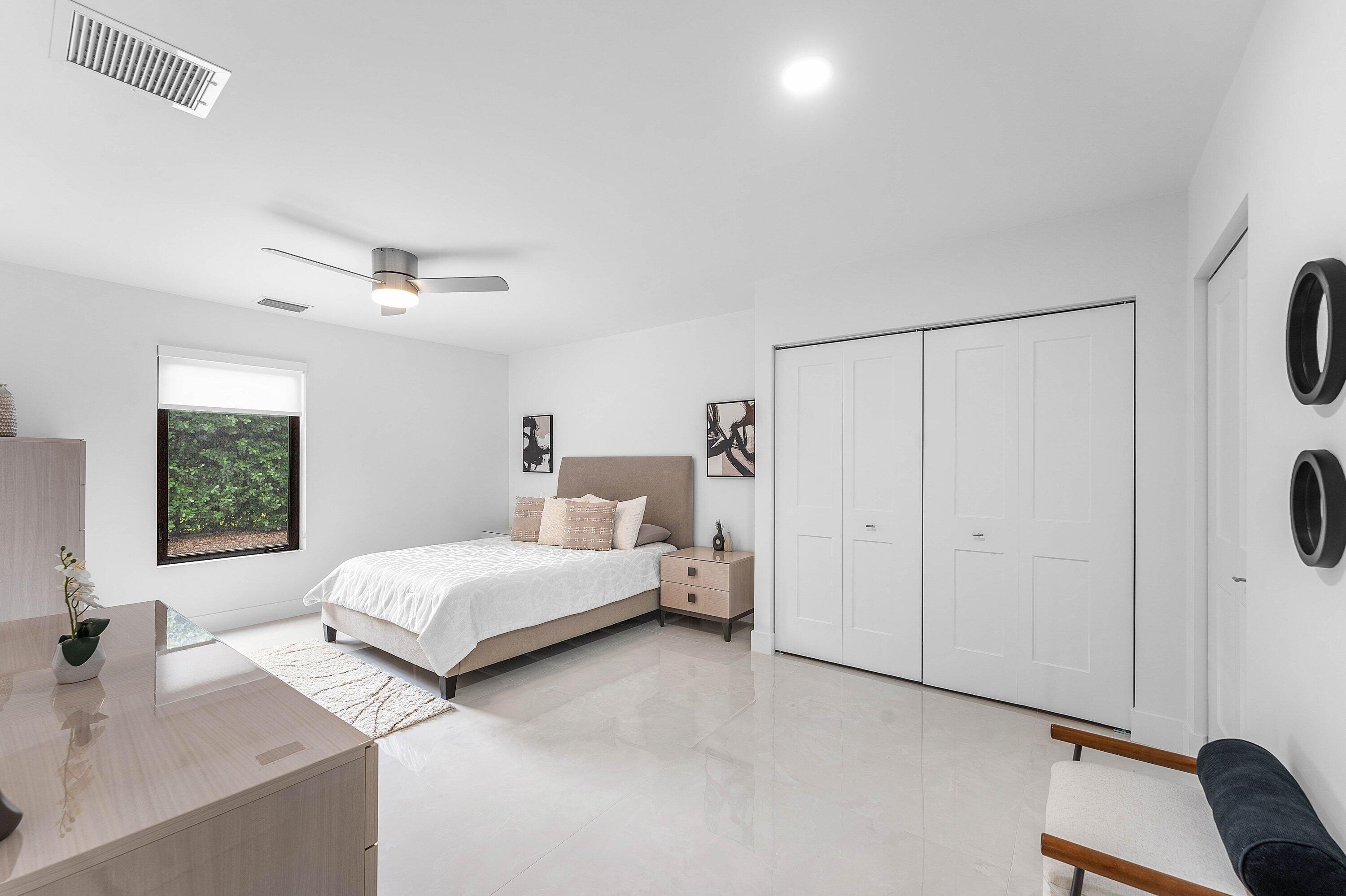 8274 Sawpine Road Delray Beach, FL 33446 - Photo 25 of 63 a spacious bedroom with a bed and a couch