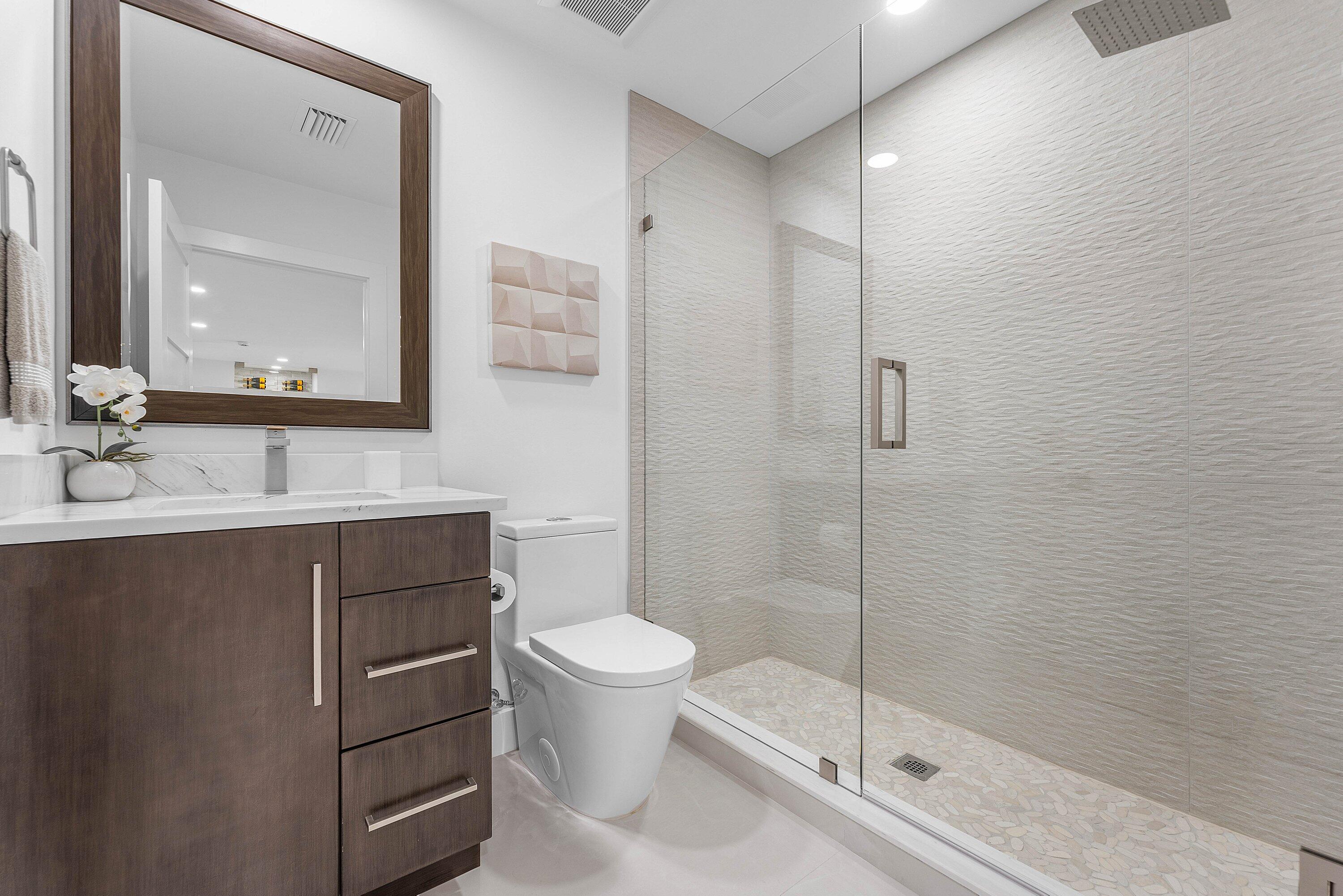 8274 Sawpine Road Delray Beach, FL 33446 - Photo 27 of 63 a bathroom with a sink a toilet and shower