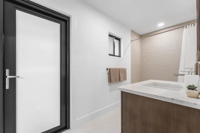 an aerial view of a residential houses with outdoor space and swimming pool