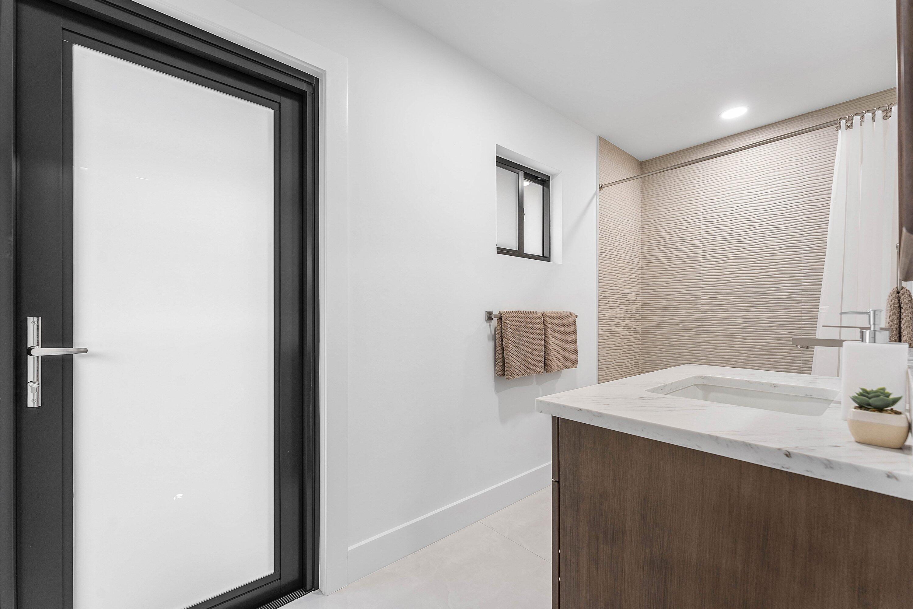 8274 Sawpine Road Delray Beach, FL 33446 - Photo 30 of 63 a bathroom with a sink and a mirror