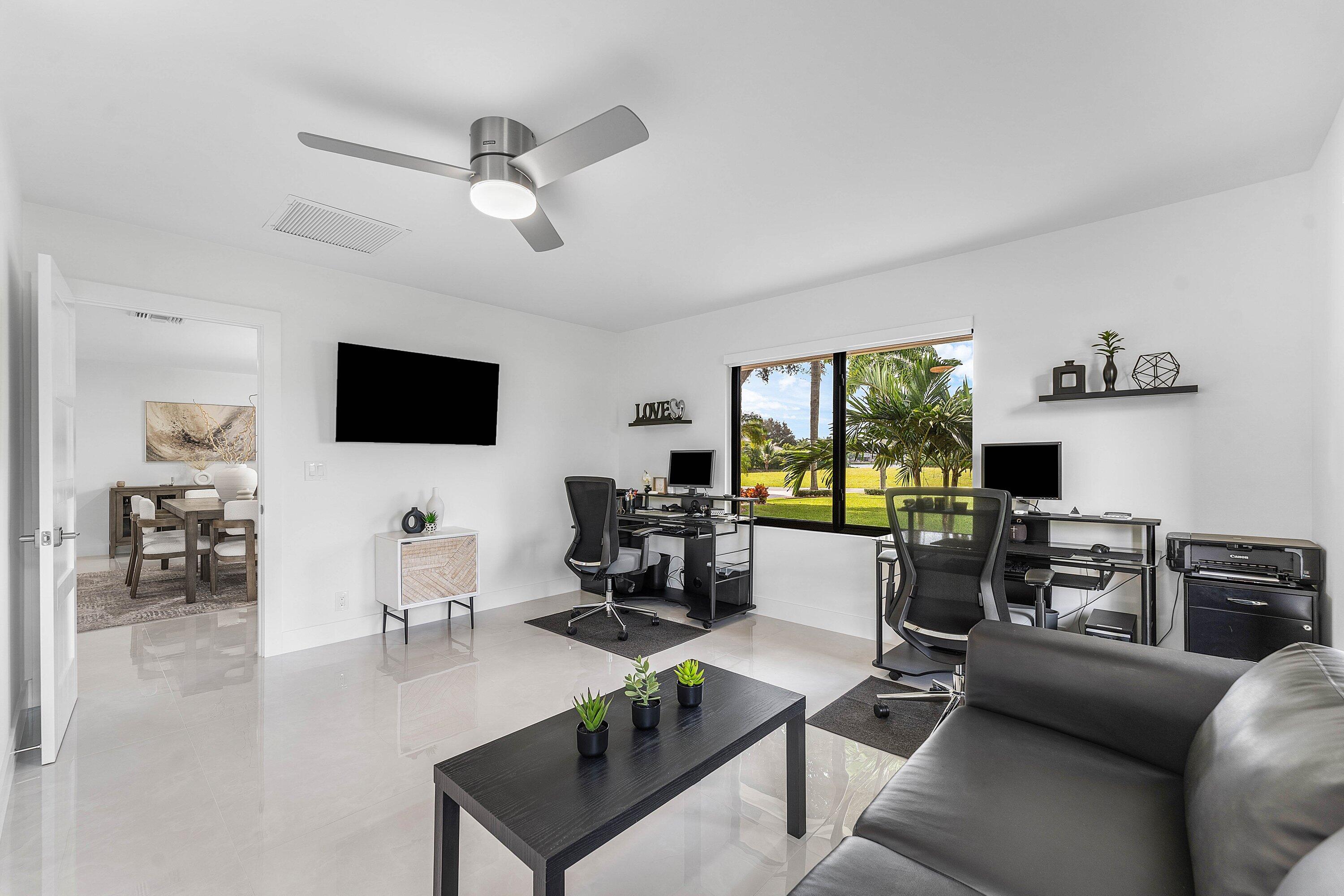 8274 Sawpine Road Delray Beach, FL 33446 - Photo 31 of 63 a living room with furniture a flat screen tv and a fireplace