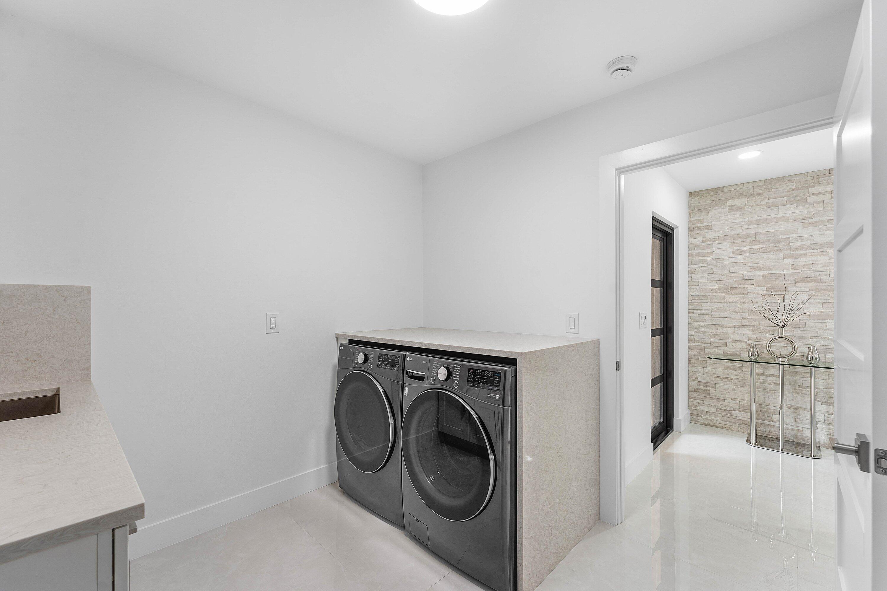 8274 Sawpine Road Delray Beach, FL 33446 - Photo 33 of 63 a utility room with dryer and washer