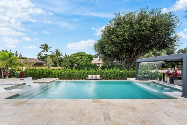 a view of a house with swimming pool and sitting area