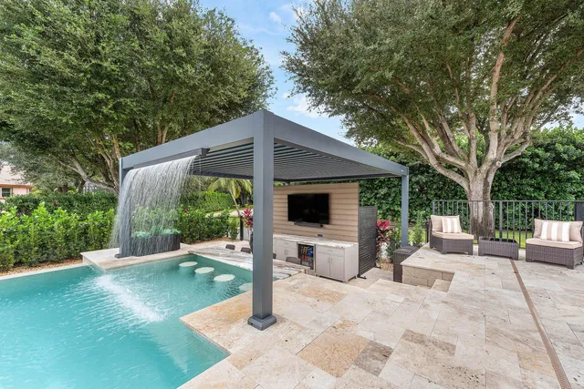 a view of a patio with table and chairs under an umbrella