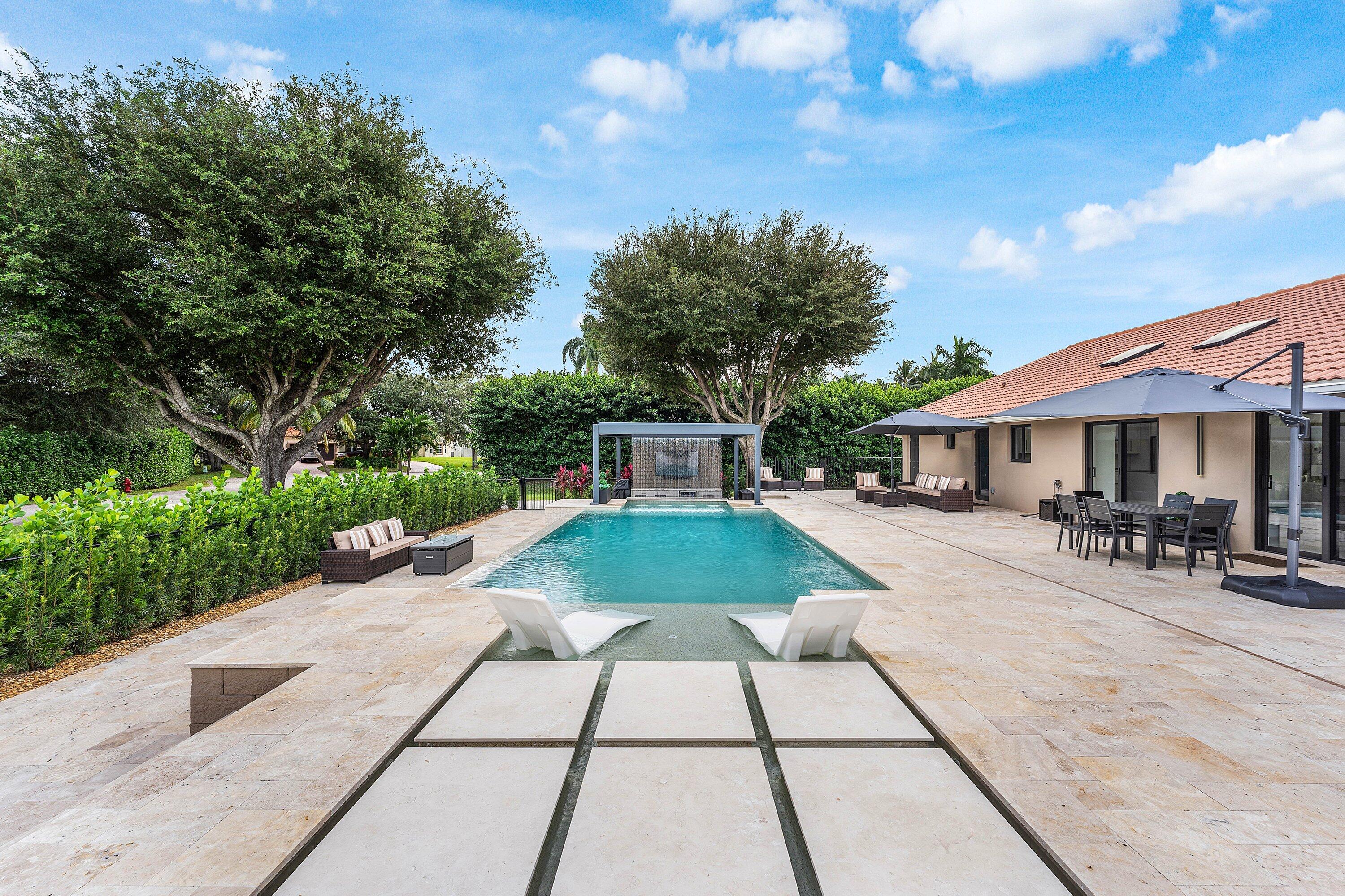 8274 Sawpine Road Delray Beach, FL 33446 - Photo 40 of 63 a front view of a house with garden