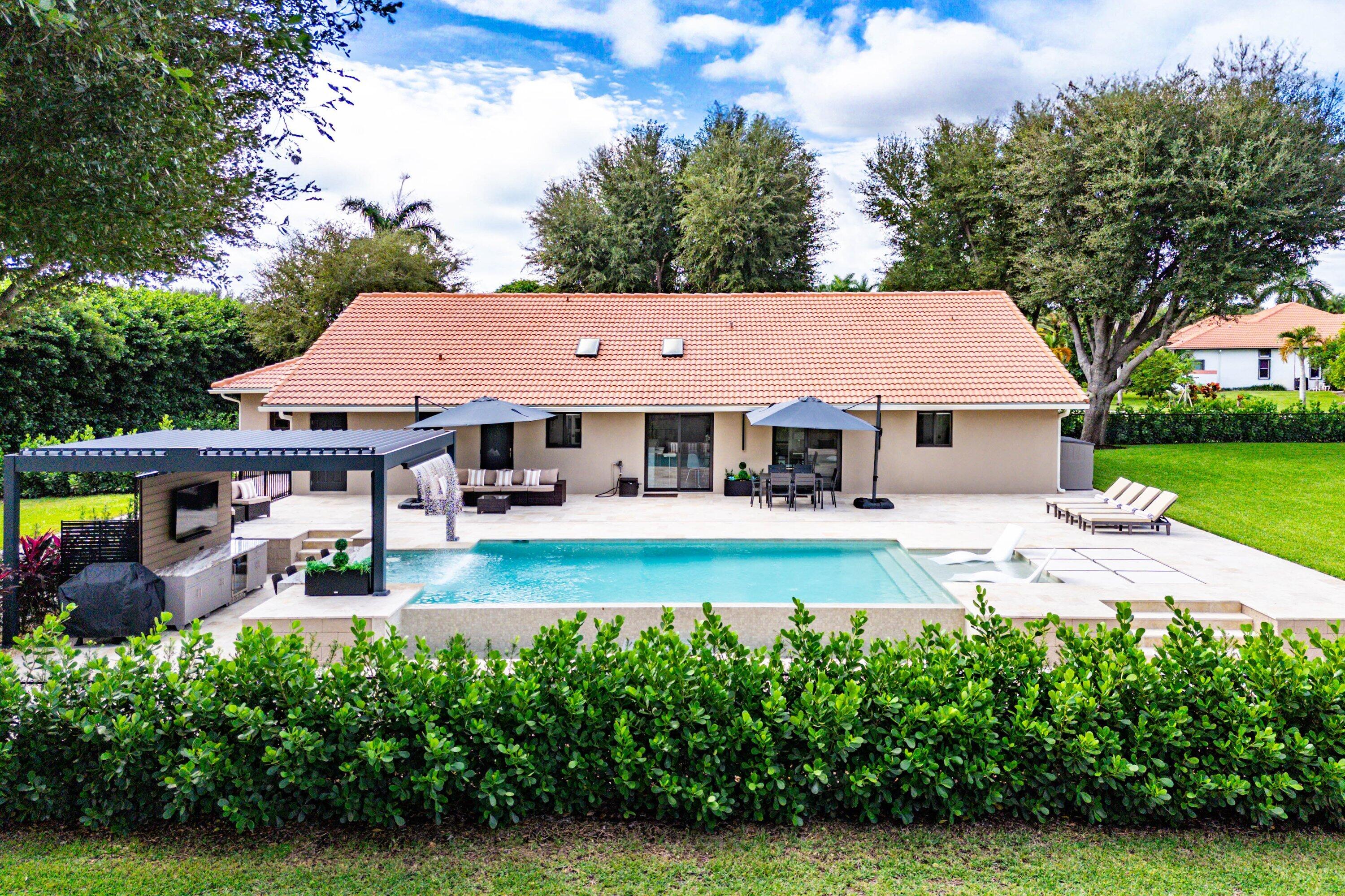 8274 Sawpine Road Delray Beach, FL 33446 - Photo 45 of 63 an aerial view of a house with swimming pool garden and patio