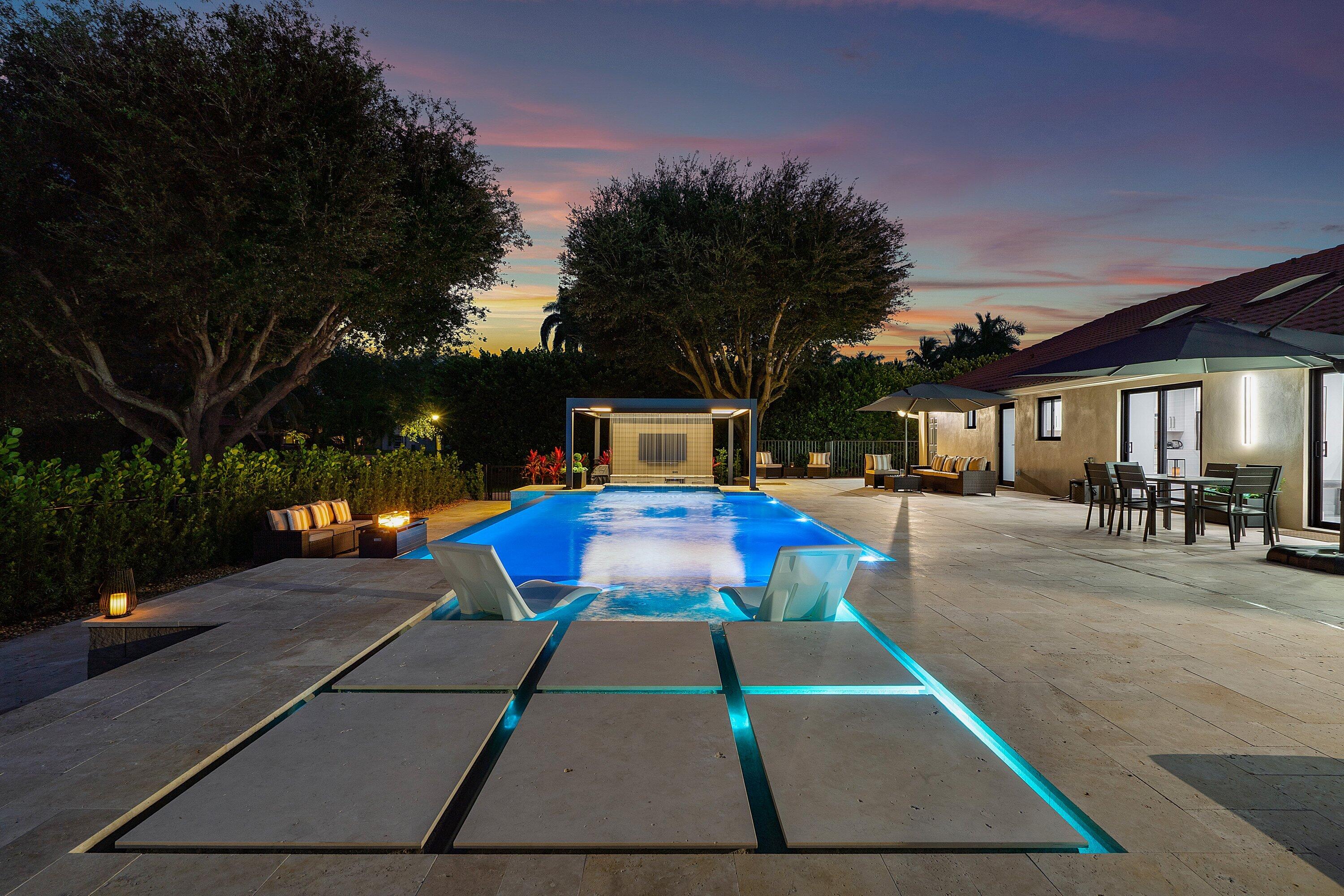 8274 Sawpine Road Delray Beach, FL 33446 - Photo 55 of 63 a view of a patio with table and chairs with wooden floor and fence