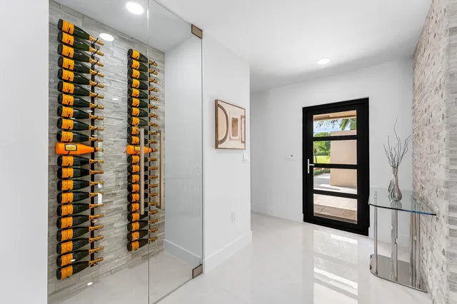 a dining room with furniture and large window