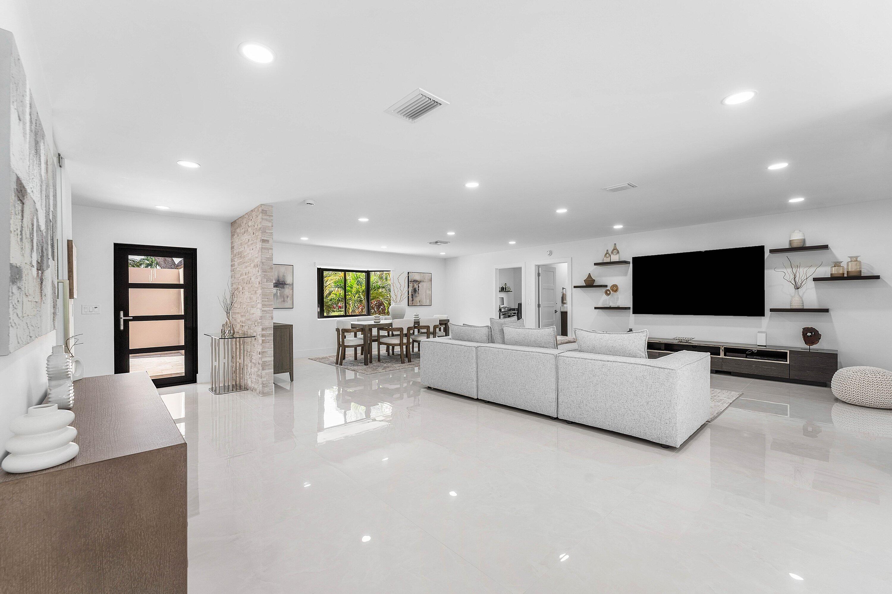 8274 Sawpine Road Delray Beach, FL 33446 - Photo 8 of 63 a living room with furniture and a flat screen tv