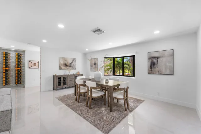 a kitchen with stainless steel appliances granite countertop a stove a refrigerator and a white cabinets